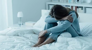 Woman upset in bed